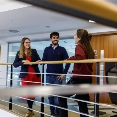 3 people in an office talking 