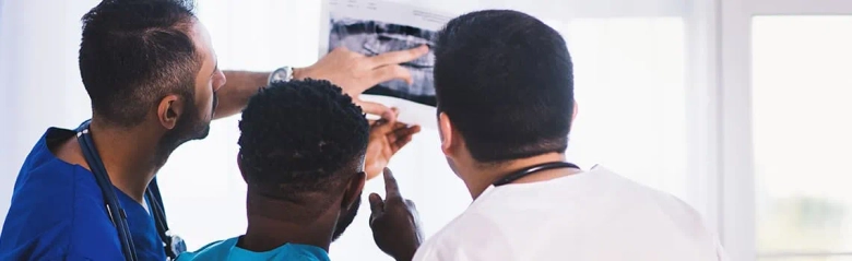 A trio of doctors analysing a patient's scan. 