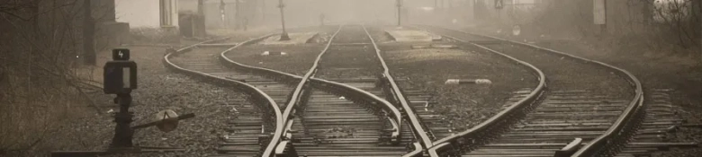 Railway tracks diverging in multiple directions on a foggy day.