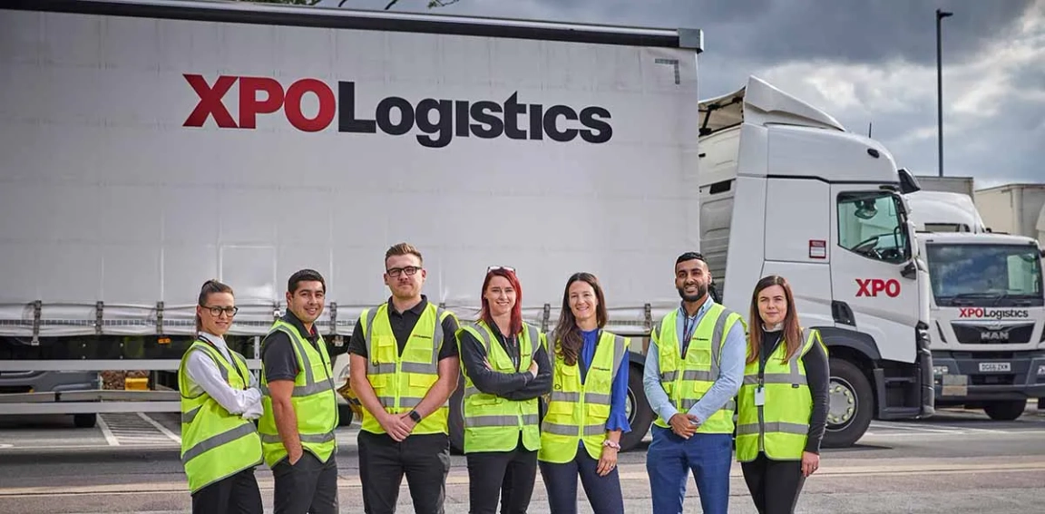 A group of people stood infront of an XPO lorry 