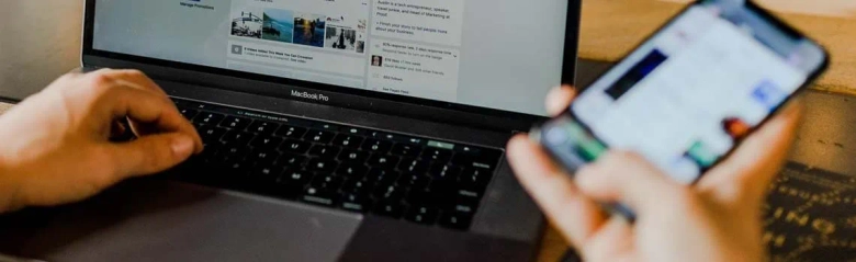 The image shows a public relations officer working on a phone and computer