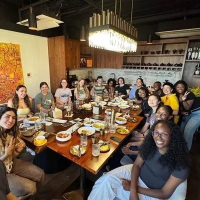 a group of people sat at a table eating 