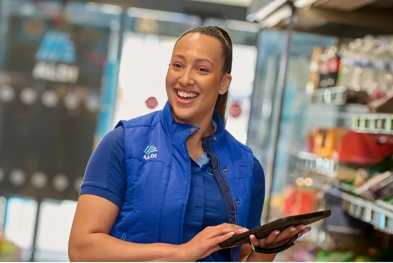 A female happily doing her job at Aldi
