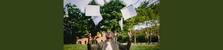 A student throwing his exam papers in the air