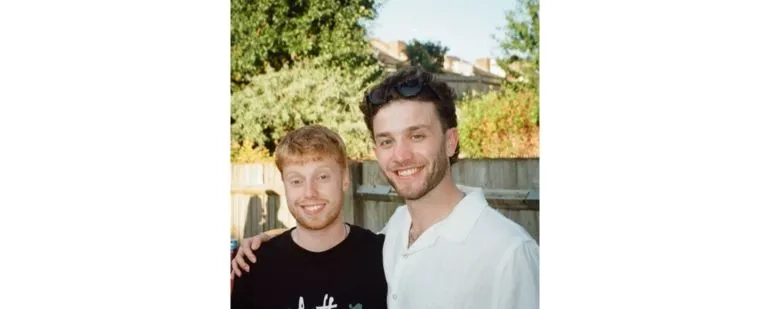 Two males smiling at the camera