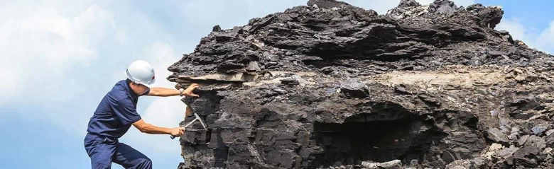 A geologist working on a rock face