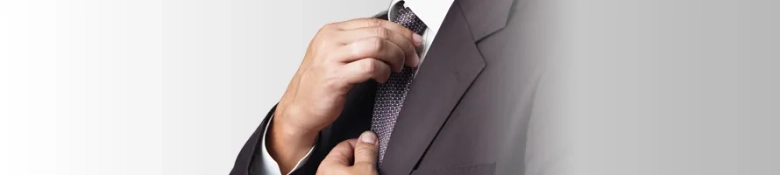 Image shows a budding vac schemer straightening a tie