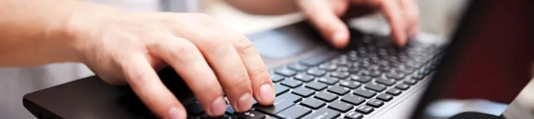 Person typing on keyboard, accessing LinkedIn