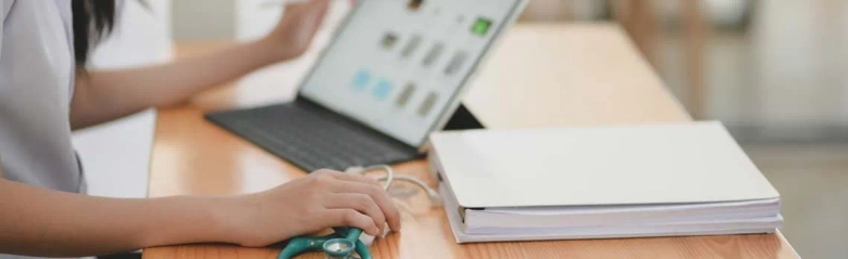 The picture shows a medical sales representative working at a laptop. 