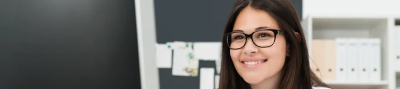 Student smiling at a computer screen, indicating that she is confident about her search for work experience